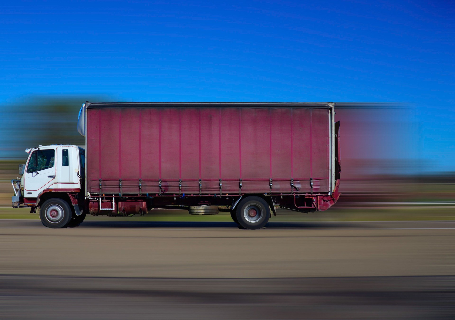 Truck on Sydney freeway travelling fast towards Melbourne from Sydney with background motion blur NSW Australia
